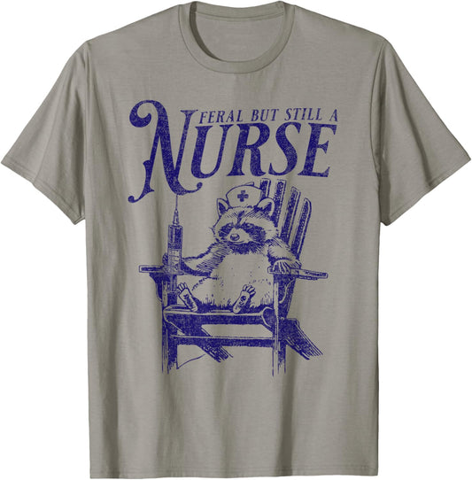 Feral But Still A Nurse Funny Feral Nurse Raccoon Nurse T-Shirt - T-Shirt | Sand